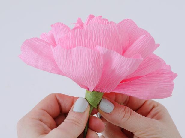 To complete the crepe paper peonies add the last petals near the bottom, and wrap floral tape down to the wire.
