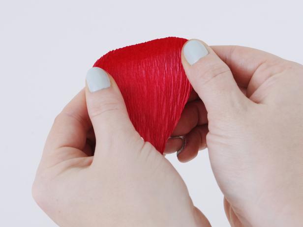 Hold the top of each petal between your thumb and forefinger and stretch the crepe paper open to make the petal look more realistic.