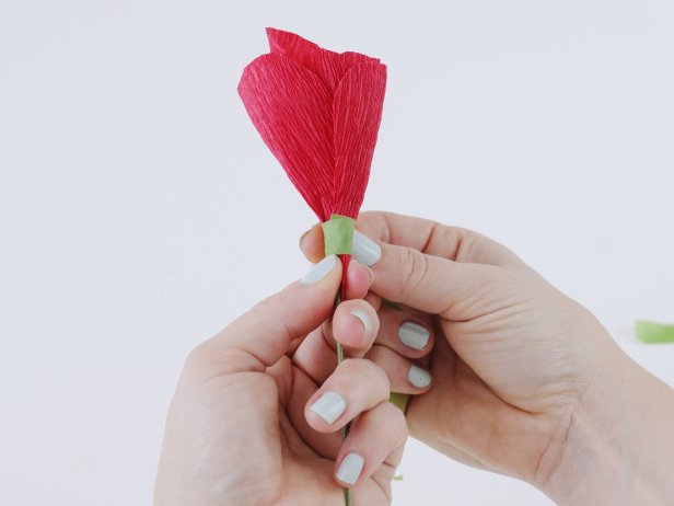 Secure the petals with a strip of floral tape. Arrange the outer petals by overlapping each one, and secure with floral tape. Wrap the floral tape all the way down to the wire to create a seamless look.