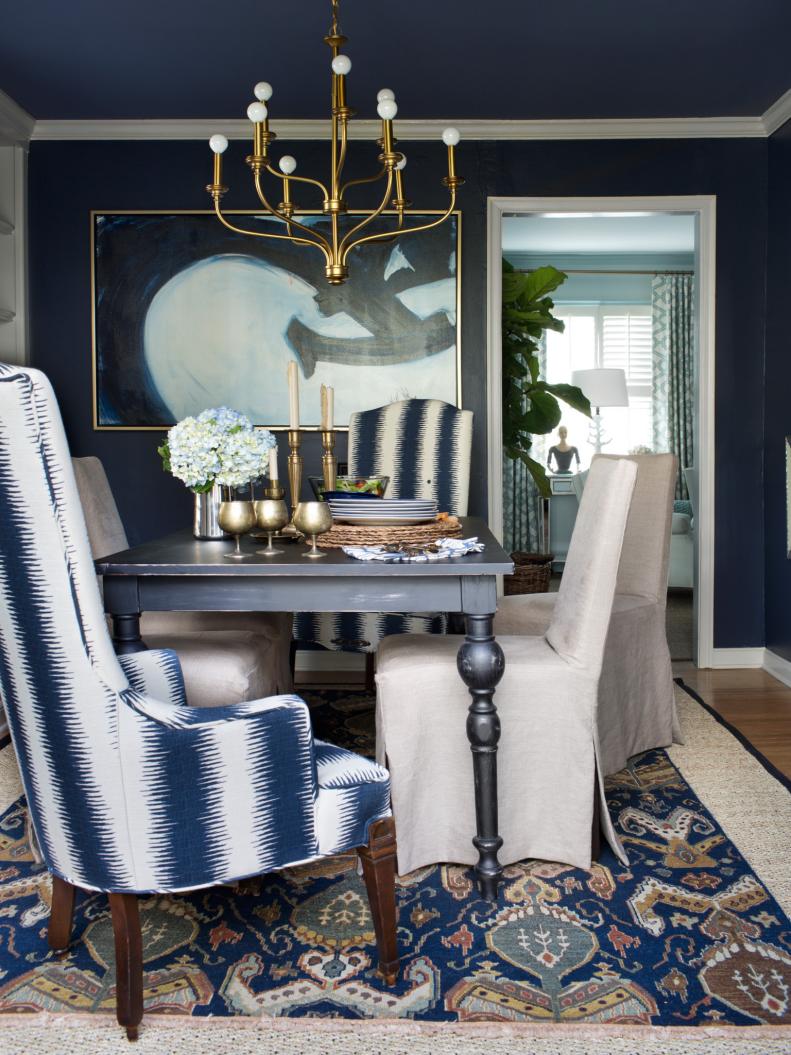 Gold accessories add a color pop to blue and gray dining room.