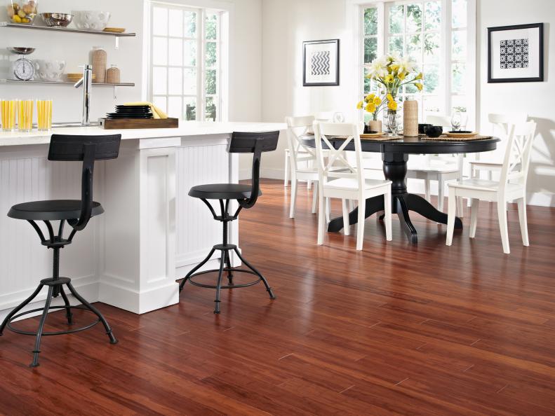 Dining Room and Bar With Exotic Wood Floors and Round Dining Table