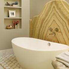 Bathroom With Soaking Tub and Honey Onyx Backsplash