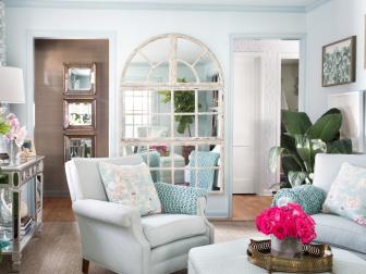 Light Blue Sitting Room With Upholstered Armchairs and Large Mirror