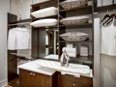 Borrowing from the master bedroom's color scheme, the master closet offers clever storage solutions.