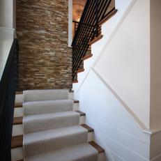 Contemporary Stairway With Stacked Stone Wall