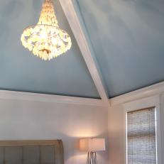 Master Bedroom Chandelier Hangs From Blue Ceiling