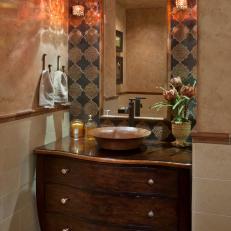 Bathroom With Ornate Mirror and Vessel Sink