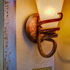 Bronze Sconce Lights Up Mediterranean Bathroom