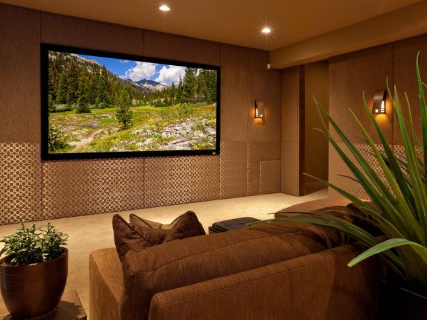 Media Room With Brown Padded Wall Panels and Soft Sconce Lighting