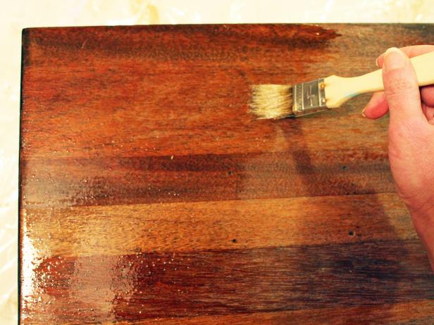 Allow stain to fully cure, following manufacturer's recommended dry time, then brush on a coat of polyurethane following the wood grain and consistently checking for drips or any lost brush bristles.