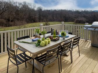 Outdoor Entertaining Space With Wood Dining Table and Metal Chairs