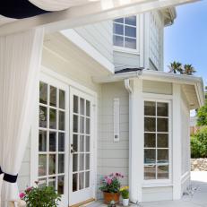 Cape Cod-Style House With Patio Pergola Curtains