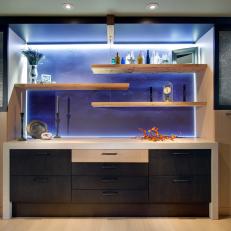 Floating Shelves Hung on Illuminated, Blue Accent Wall
