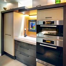 Contemporary Kitchen Nook Back-Lit With Wall Ovens