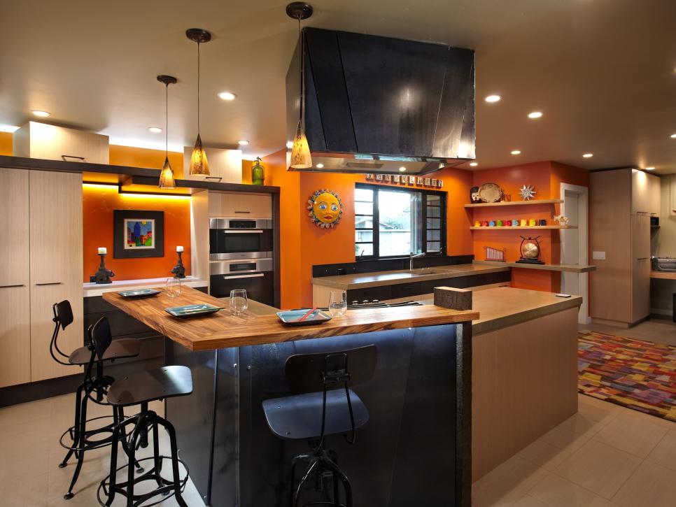 Contemporary Kitchen With Orange Walls and Metal Island
