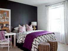 Bedroom With Black Walls and Purple Bedspread