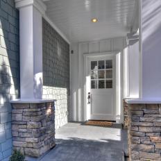 Coastal-Style Entry With Stone-Wrapped Columns