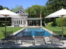 Luxurious Backyard Swimming Pool With White Umbrellas