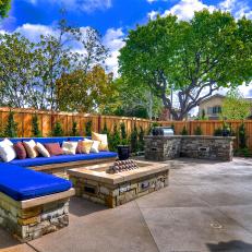 Outdoor Kitchen Area With a Stone Fire Pit 