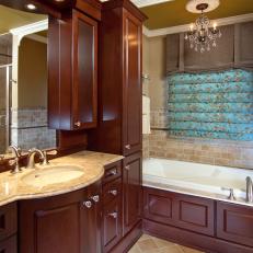 Olive-Green Bathroom With Cherry Wood Cabinetry 