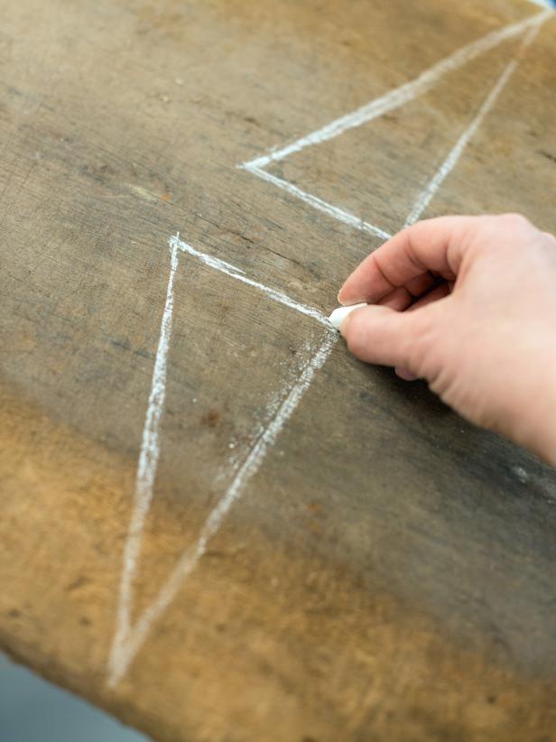 Use chalk to draw desired outline onto wood.