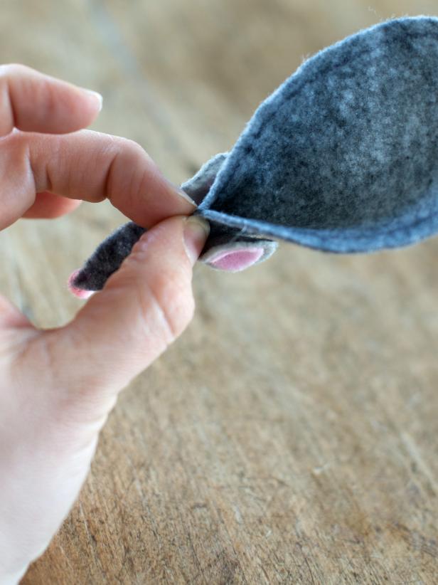 Pinch felt mouse together under the ears; apply a dab of preferred glue between pinched layers of felt and hold until dry.