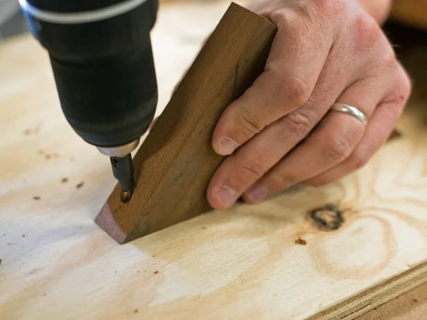 Drill pilot holes where top and bottom of cookbook stand support meets back.