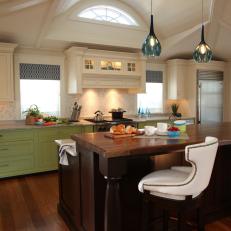 Spacious Kitchen With Wood Island and Green Cabinets