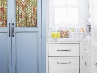 Blue Kitchen Cabinet with Fabric-Covered Windows
