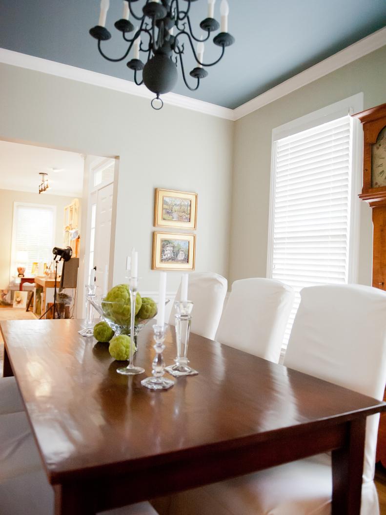 A dark gray ceiling in a white dining room. 