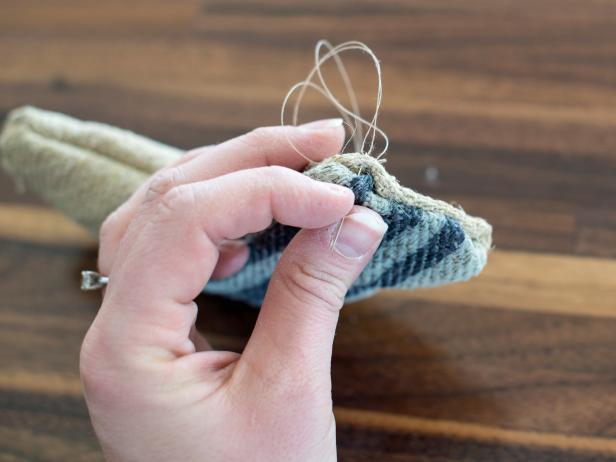 Once stocking toy is filled with cat nip, fold ends of stocking top in and stitch closed by hand with an all-purpose sewing needle and coordinating thread.