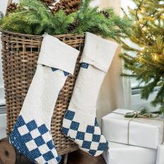 Blue and White Stockings Hung on Basket of Greenery
