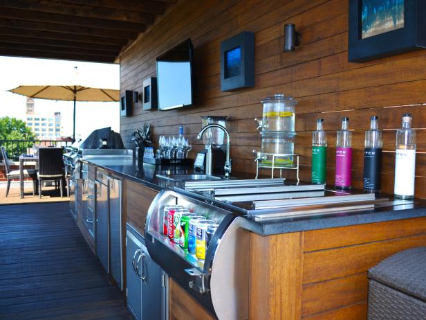 Outdoor Bar with Stainless Steel Appliances and Wall-Mounted TV