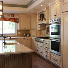 Kitchen Featuring Integrated Refrigerator with Wall Ovens and Prep Station