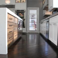 Dark Hardwood Floors Set off White Cabinets in this Transitional Kitchen