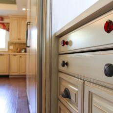 Red and Oil-Rubbed Bronze Drawer Knobs in Kitchen