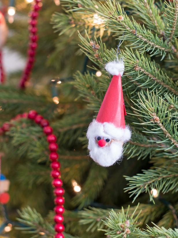 Attach another ornament hook to the wire ring glued to the top of the hat and hang the finished ornament on the Christmas tree.