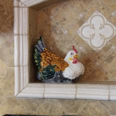Brown Tiled Niche With a Ceramic Chicken
