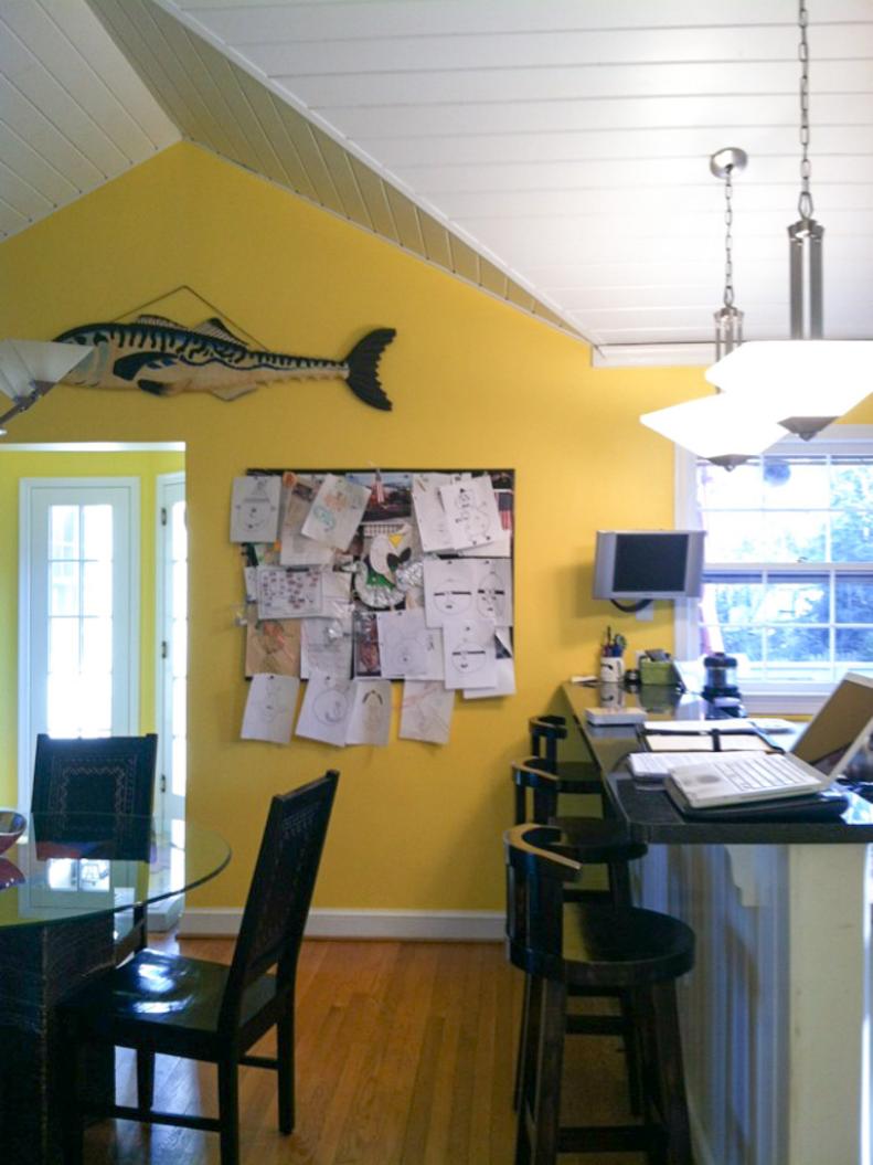 Yellow Wall With Peaked Ceiling & Cluttered Memo Board