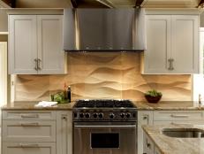 Neutral Kitchen With Gray Cabinets and Limestone Backsplash