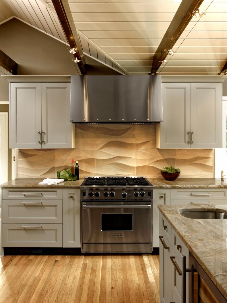 Neutral Kitchen With Gray Cabinets and Limestone Backsplash