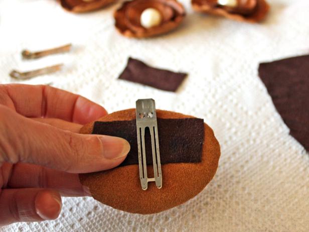 Place clip glue-side-down on the back of the leather flower and firmly press the fabric and leather together to create the pin.