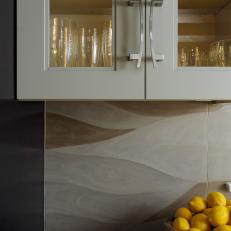 Glass-Front Cabinets & Sculpted Limestone Backsplash