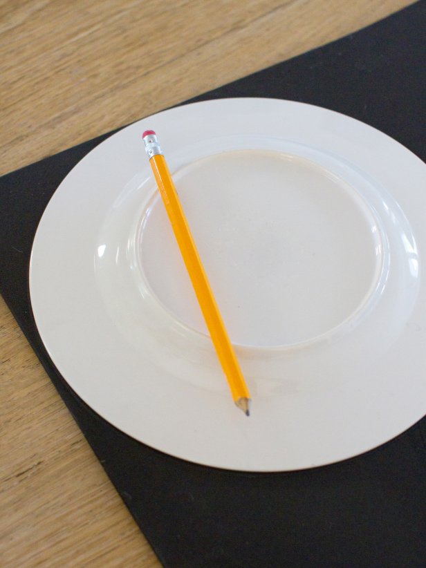 Place a salad plate on top of a sheet of black craft foam, trace around it with a pencil then cut out the circle with a pair of scissors.