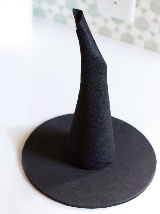 Use hot glue to attach the felt-covered cone to the brim.