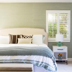 Calming Green Bedroom With Wood Shutters and Textured Wallpaper
