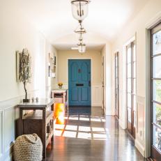 Neutral Hallway With Blue Door and Nautical Decor