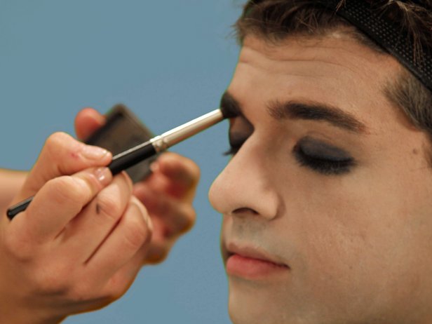 To intensify the dark, masculine nature, use the rounded brush and a little gray eye shadow to shade the inside of your eyes up to your eyebrows.