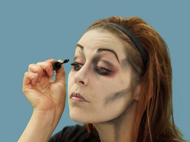 After applying eye liner and eye shadow, complete your zombie eye by adding mascara in a haphazard manner.