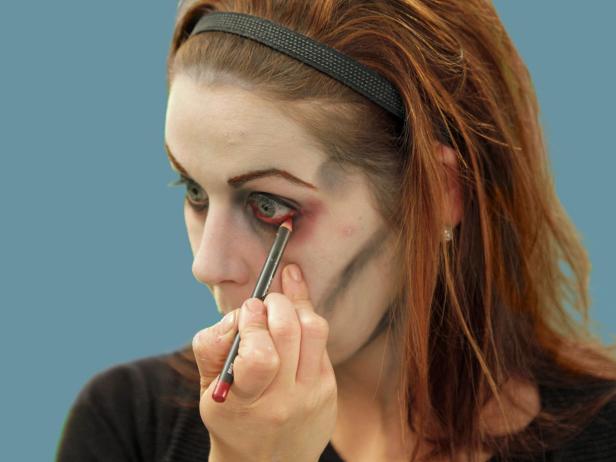For the perfect undead zombie eyes, add red eye liner to the water line of the eye. This will make the eyes appear tired and sickly.